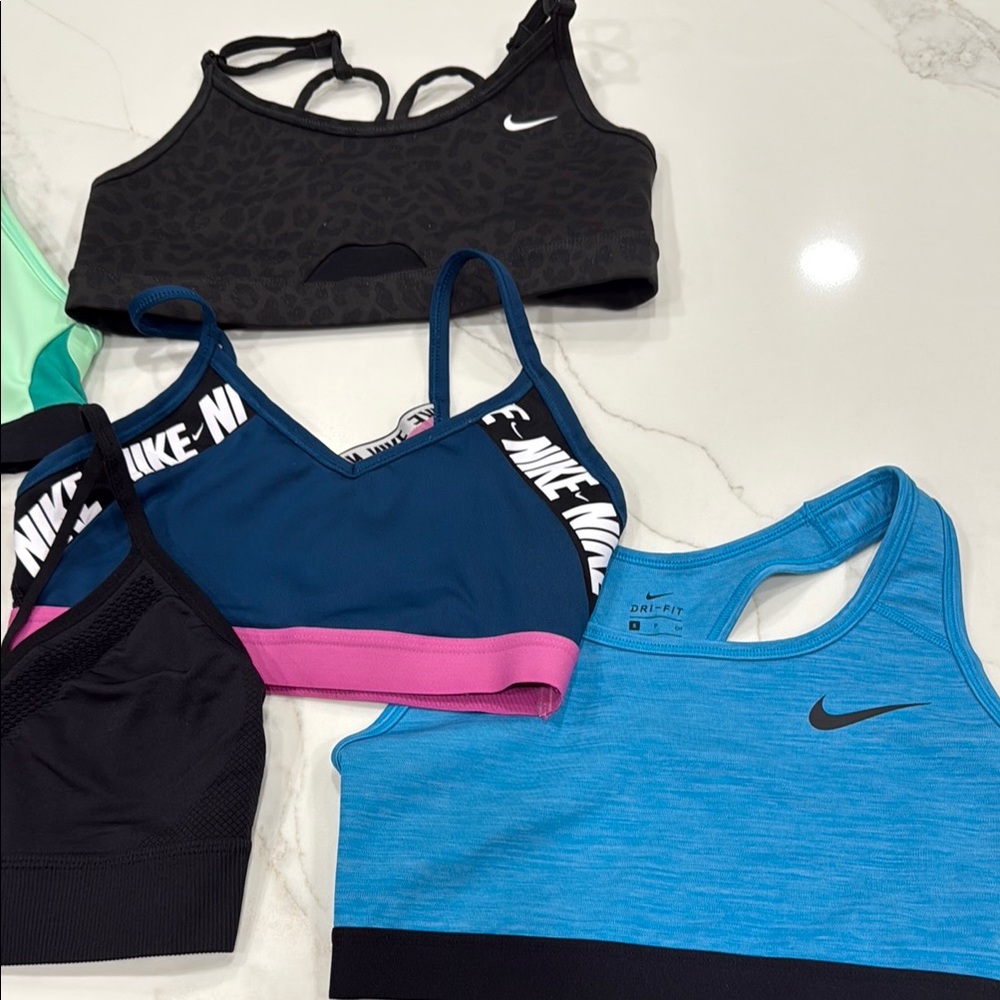 Set of 6 Nike Sports Bra Collection in various colors and patterns.